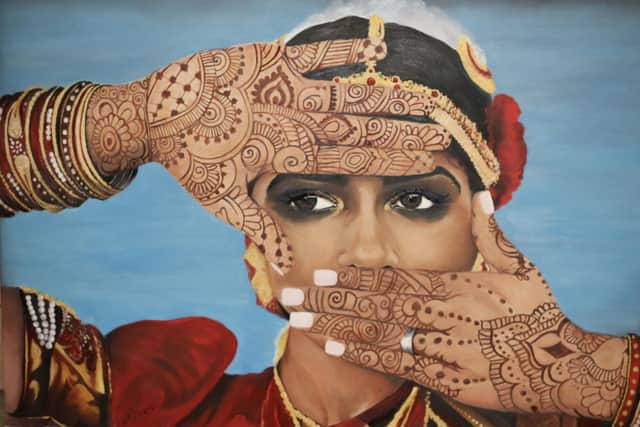 Sue Dickins' portrait of Rasika with henna decorated hands on her wedding day