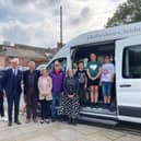 Children returning from holiday with representatives from Rotheras and the charity