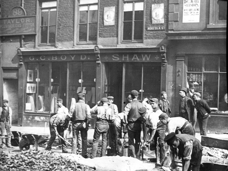 Workers laying telephone cables in 1887 on Norfolk Street, seen here from Norfolk Row. Ref no: s18330