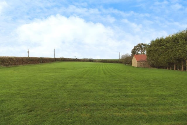 Beyond the rear garden at the £900,000 Elmton farmhouse is a substantial, grassed paddock area.