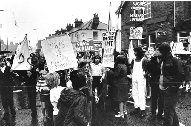 Banner-waving children and parents protest about road safety at a crossing on Derby Road, Chesterfield, in July 1973.