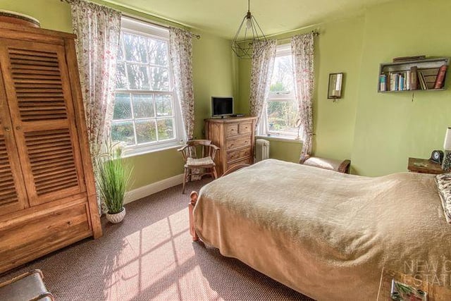 Natural light floods in through sash windows in this double bedroom.