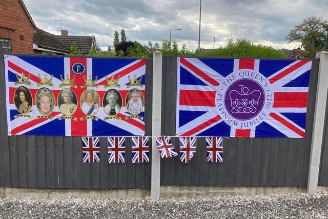 Union Jack flags and images of the Queen can be seen around the village