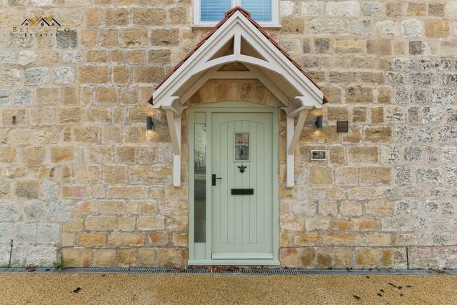 The welcoming and characterful front door to the £450,000 stone barn conversion.