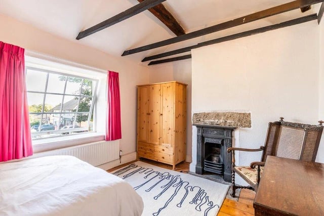 There's an attractive cast iron fireplace in this bedroom.
