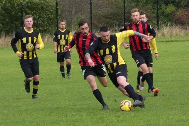 Hasland Community (in yellow and black) try to break through midfield during the clash with Spartans in HKL Five in October.
