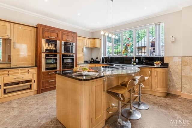 Conveniently located next to the dining room is this incredible kitchen, which features no fewer than three ovens (conventional, combi and steam). It has a solid wood finish in a tasteful combination of dark walnut and sugar maple colours, and features granite worktops.