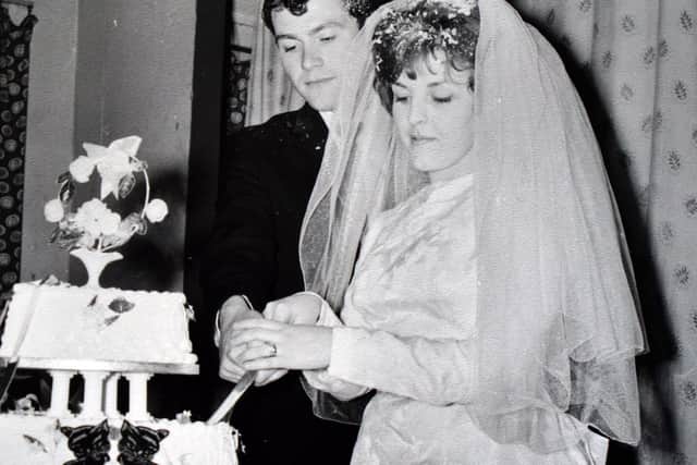 The new Mr and Mrs Chapman cut their wedding cake at their reception in St Peter's Church hall in Calow in 1963.