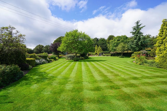 An extensive lawn and raised beds with a greenhouse and a summer house are contained within the landscaped grounds.