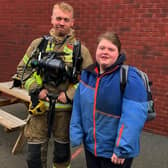 A Shirebrook firefighter poses with a pupil at Stubbin Wood School.