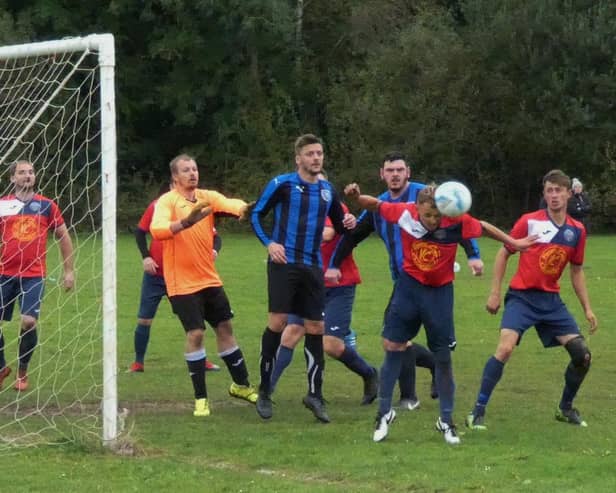 Dronfield Wanderers (stripes) got their first win of the campaign. Pic by Martin Roberts.