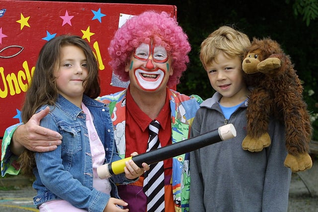 Clowning Around - Jade Morton,7, and Mark Thornley,6, of Matlock meet Uncle Michael at the Castle View Primary school Summer Fayre.