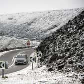 A car navigates the Snake Pass in Derbyshire, as a blast of snow hits the north of England. Photo: Danny Lawson/PA Wire