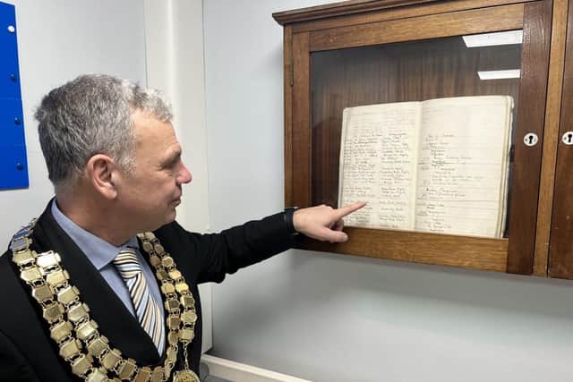 The Mayor reads a piece of history showing local donations from the community dating to 1931