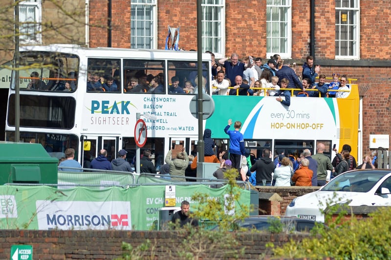 Players and family waving to the crowds on route.