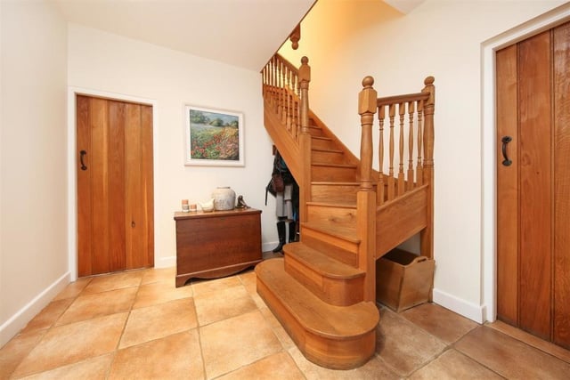 An eye-catching wooden staircase curves as it rises to the first floor.