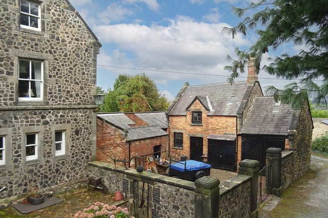 A former coach house and wash house are located in a cobbled courtyard to the side of the main house.