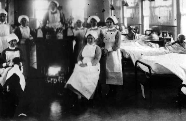 Sisters at The Royal Hospital Haslar in Gosport, huddle around a real coal fire in this undated picture