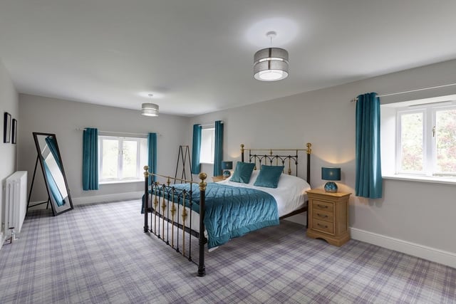 The master bedroom suite with windows and views to two sides, has an en suite bathroom with under floor heating, and both bath and rain-head shower.