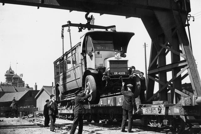 An old double decker bus is loaded onto a railway wagon for its last journey, to Chesterfield to be broken up, on May 26, 1937. The upper deck was being rmoved to enable it to fit within gauge.  (Photo by Topical Press Agency/Getty Images)