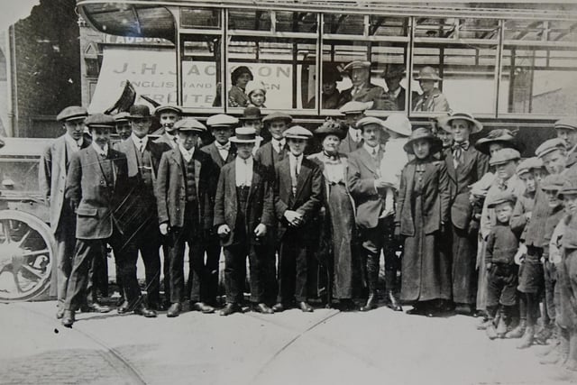 Going on a outing? A group of people standing outside Chesterfield tram depot  in the 1920s