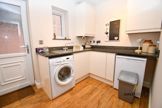 Just off the kitchen is this handy utility room, which includes space and plumbing for a washing machine.