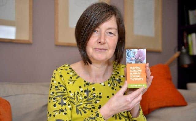 Derbyshire woman Tricia Black with a suicide prevention leaflet she produced following her dad's death.