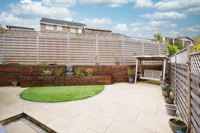 A low maintenance landscaped garden with paved patio and artificial lawn provides a safe area for children to play.