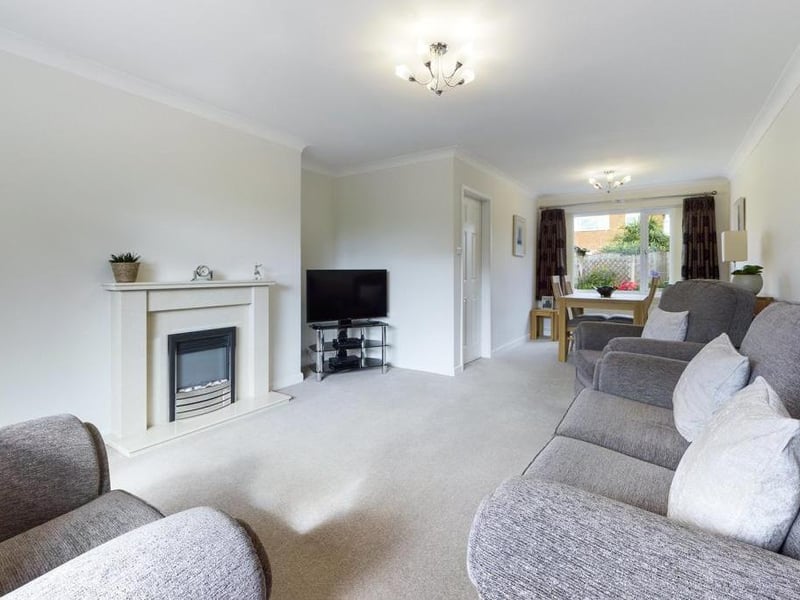 Lounge/dining room - Double aspect room with uPVC double glazed window to the front elevation, feature fireplace with inset and raised hearth incorporating electric fire unit, uPVC double glazed window to the rear elevation, two radiator panels and power points.