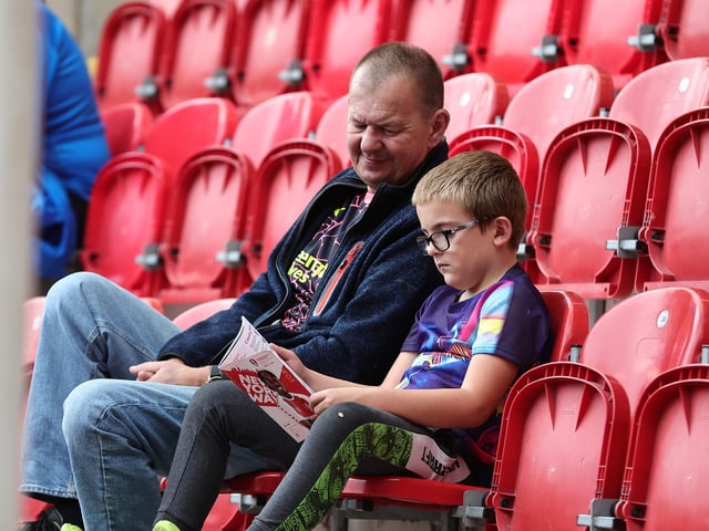 Perusing the match programme