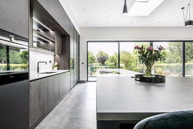 This is the kitchen - it has a calacata gold quartz worktop with handleless units, LED lighting and a range of integrated appliances including a Siemens tall fridge and freezer, a Quooker boiling water tap, two Siemens electric ovens, a wine cooler and a BORA induction hob.