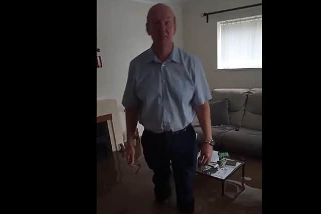 In a video which he shared with Derbyshire Times Mark Allen can be seen wading through the brown water in his hallway as framed pictures float past.