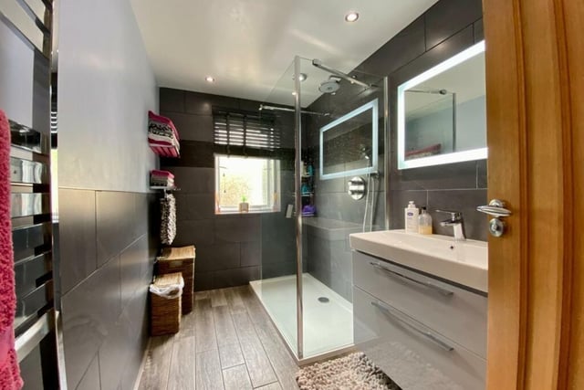 This shower room on the ground floor has recently been refitted with a modern suite comprising a large walk-in shower enclosure with high pressure shower fitments, a large wash basin with storage cupboard beneath and a wc.