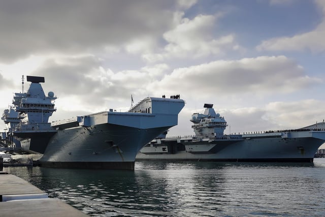 HMS Queen Elizabeth and HMS Prince of Wales, Britainâ€™s aircraft carriers, come together in their home port of Portsmouth for the first time. This image won Best Maritime Image. By Leading Photographer Ben Corbett
