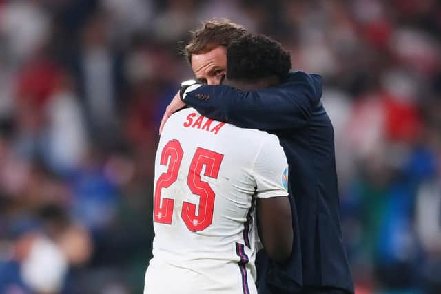 Bukayo Saka of England is consoled by Gareth Southgate, Head Coach of England following defeat in the UEFA Euro 2020 Championship Final between Italy and England at Wembley Stadium on July 11, 2021 in London, England. Photo by Laurence Griffiths/Getty Images.
