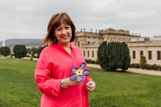 Ashgate’s Chief Executive, Barbara-Anne Walker, with a forget-me-not flower at Chatsworth House.