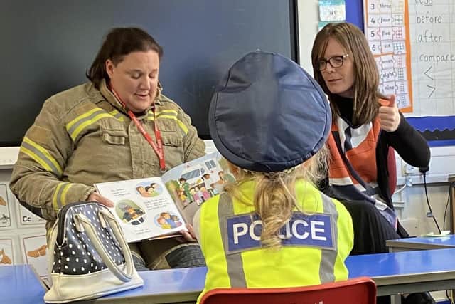 Children working with firefighters at Royal School for the Deaf Derby