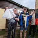 Stuart Shaw, centre, with son James and their neighbour Marcus Rhodes, holding the balloon debris. (Photo: Jenny Shaw)