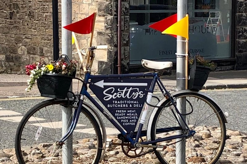 A bike decorated in red and yellow in Seahouses.