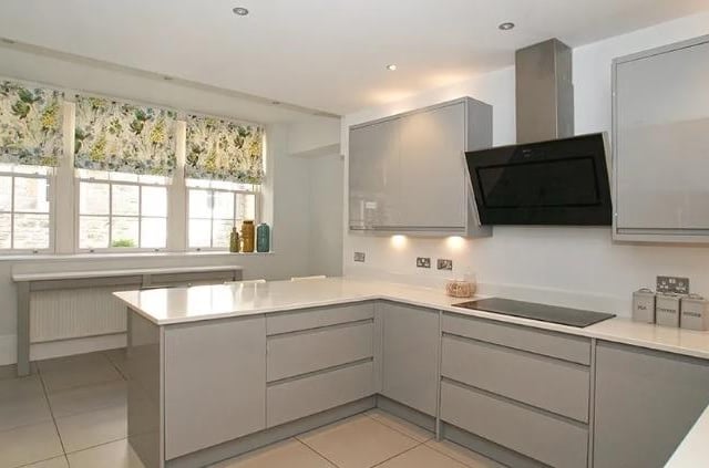 The kitchen contains eye-level self-cleaning integral appliances including electric oven and grill, coffee maker, steam oven and microwave and a glass-fronted wine fridge. Further integral appliances include a fridge freezer and 12-place setting dishwasher. The work surface extends to form a peninsula breakfast bar with seating space and storage cupboards beneath.