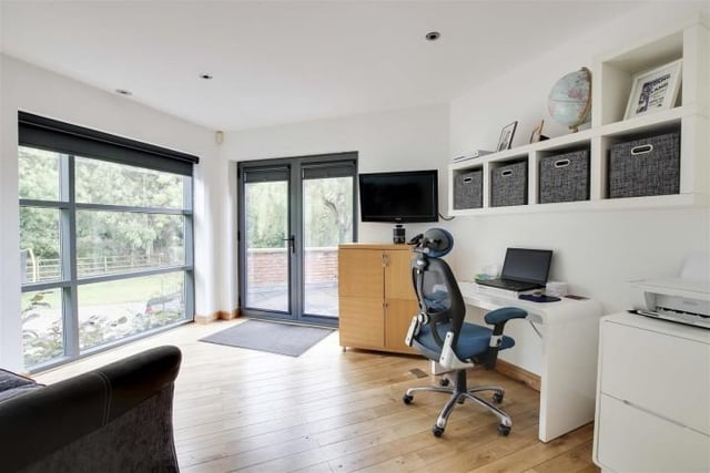 This reception room, which is currently being used as an office, has wood flooring with underfloor heating, recessed spotlights, access to a store room, full height double glazed windows and double door providing access to the front of the property.