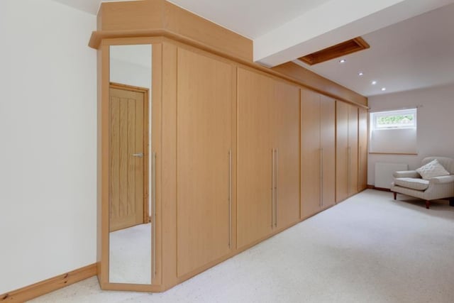 This superb dressing area has fitted furniture containing short/long hanging, shelving and a mirrored door.
