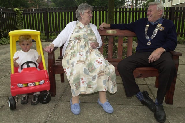 Sheffield Lions President Derek Loder enjoyed a joke with Norbury Resident Mary Aizelwood on the bench they provided at the home. Bradley Feeney rode in one of the toy cars provided to the Stradbroke Parent and Toddler group back in August 2000