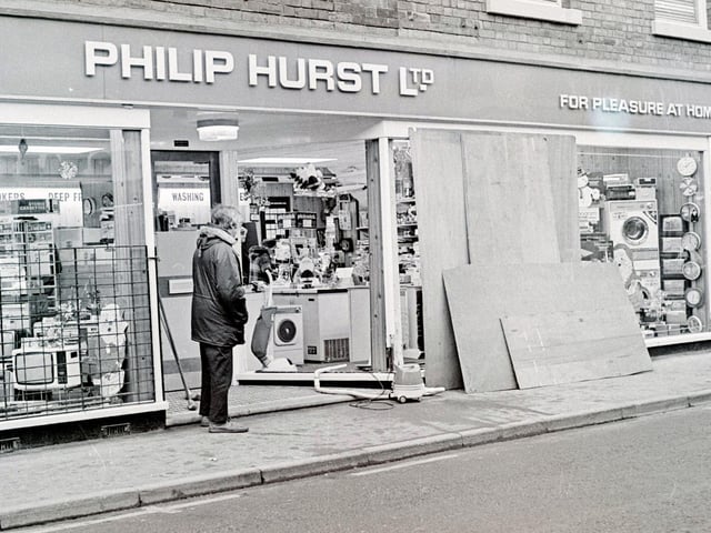 Repairing a smashed window at  Philip Hurst Ltd, in Ripley, December 1981.