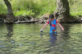 Six-year-old Moli Flanagan collects rubbish at Dovedale