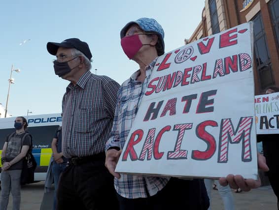 A Sunderland Unite member holds her message board during the Black Lives Matter vigil held in Keel Square.