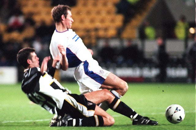County's Nick Fenton charges after the ball with Chesterfield's Jonathan Howard in 1999.