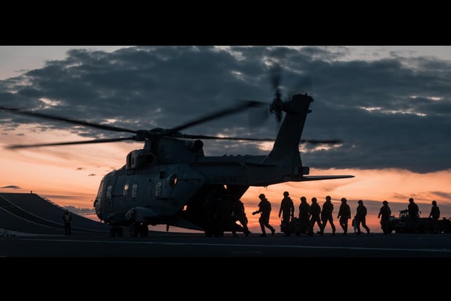 Royal Marines load up onto a Merlin helicopter during fast roping exercises on the flight deck of HMS Queen Elizabeth. This images was part of a winning selection for the Commandant General Royal Marines Prize won by HMS Queen Elizabeth. Picture by Leading Photographer Daniel Shepherd