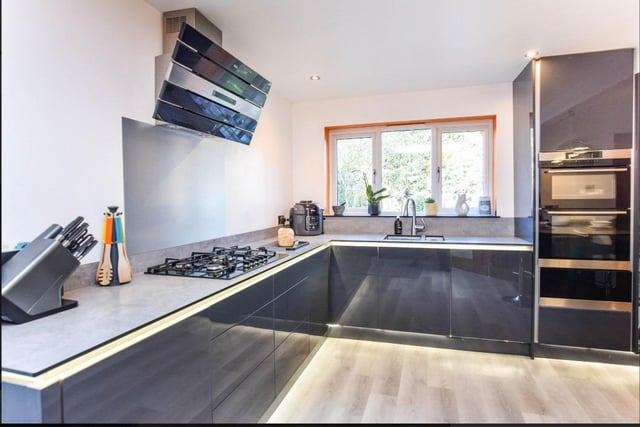 The bespoke kitchen boasts a sleek design with fully integral kitchen appliances.