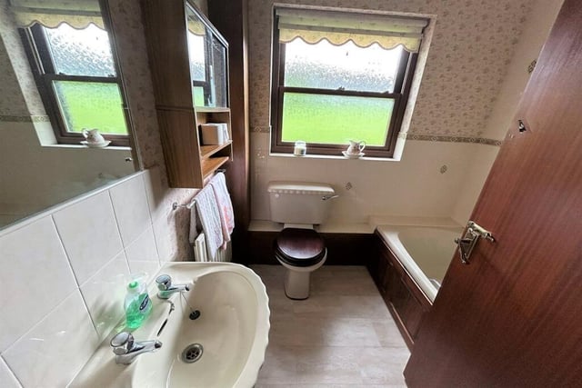 The bathroom housing a bath, sink and wc is adjacent to the principal bedroom.